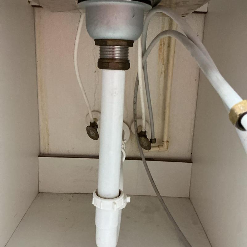 Sink drain pipe and braided supply lines under sink Sink drain pipe and braided supply lines under sink