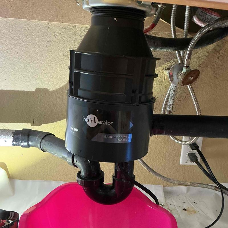 Garbage disposal unit installation under kitchen sink