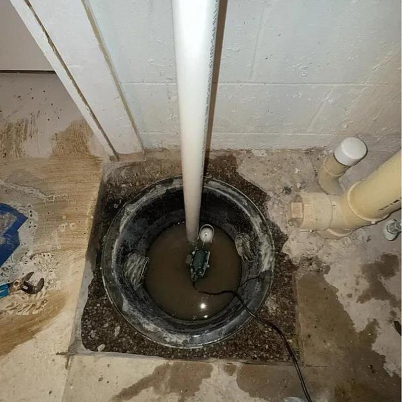 Sump basket and pump basin with water and pipes