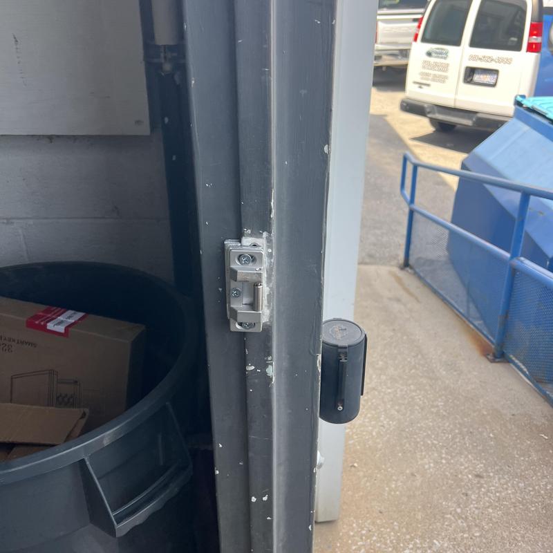 Exit device latch on metal door frame in commercial setting Exit device latch on metal door frame in commercial setting