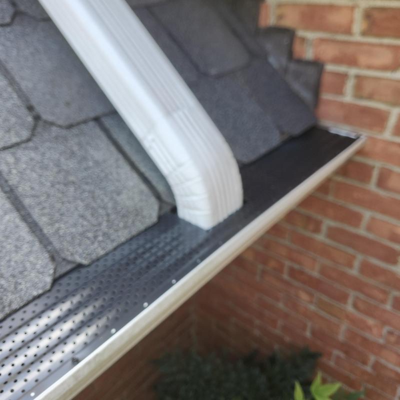 Gutter outlet with gutter guard on shingle roof