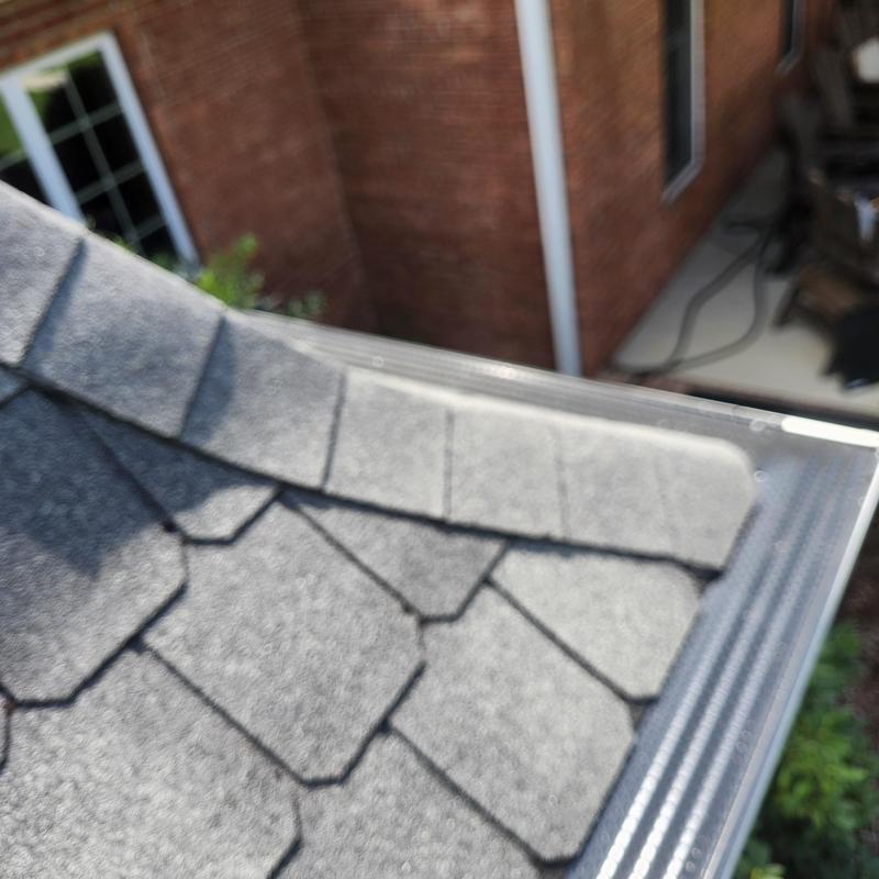 Gutter with clog at outlet causing overflow