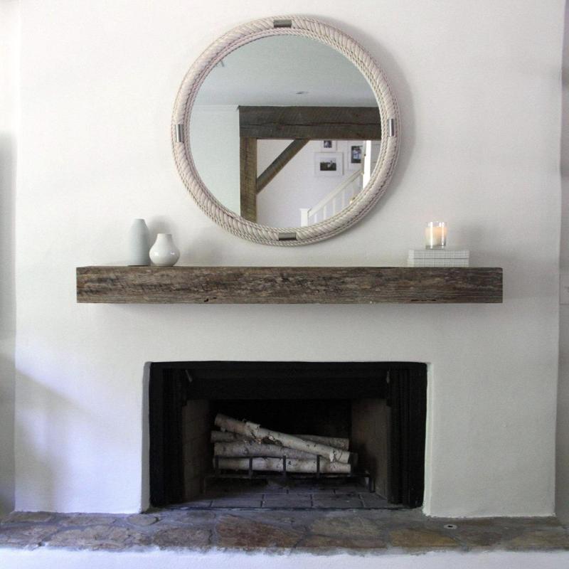 Fireplace with rustic wooden mantel and decorative mirror