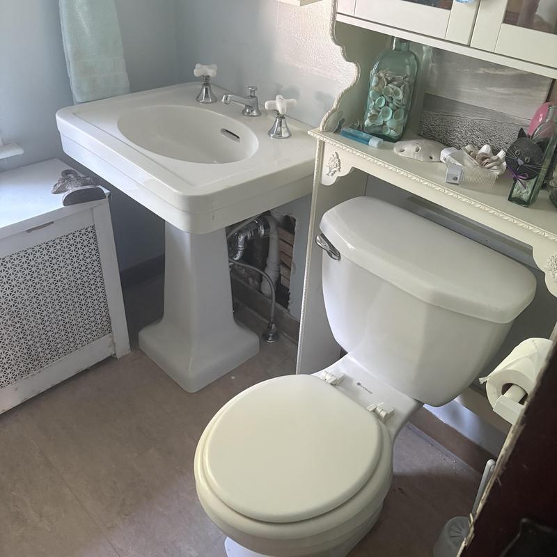 PVC drain pipes and PEX water lines under bathroom sink PVC drain pipes and PEX water lines under bathroom sink