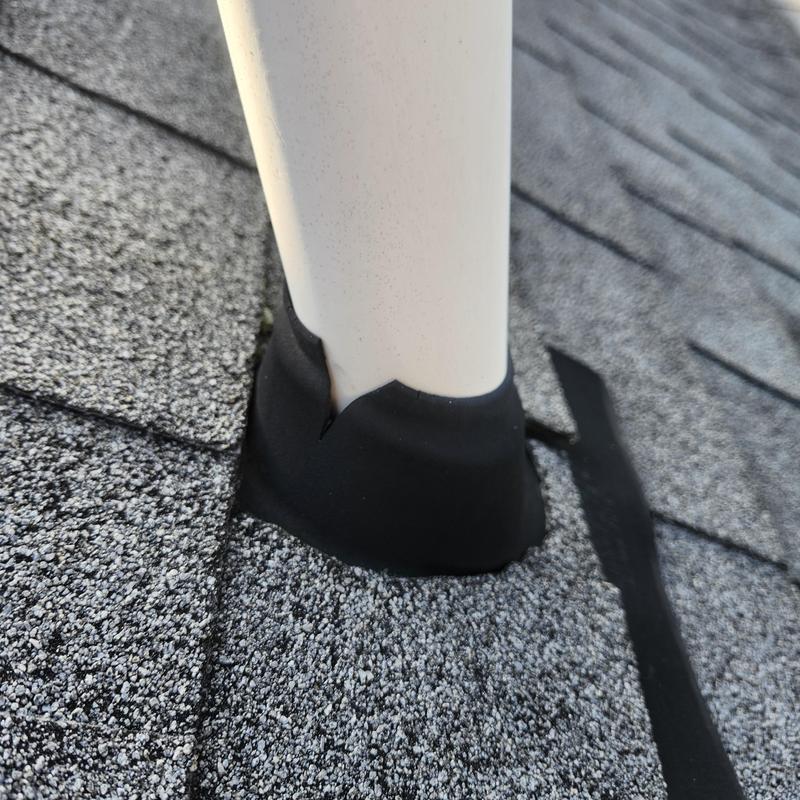 Plumbing vent collar on roof with black sealant