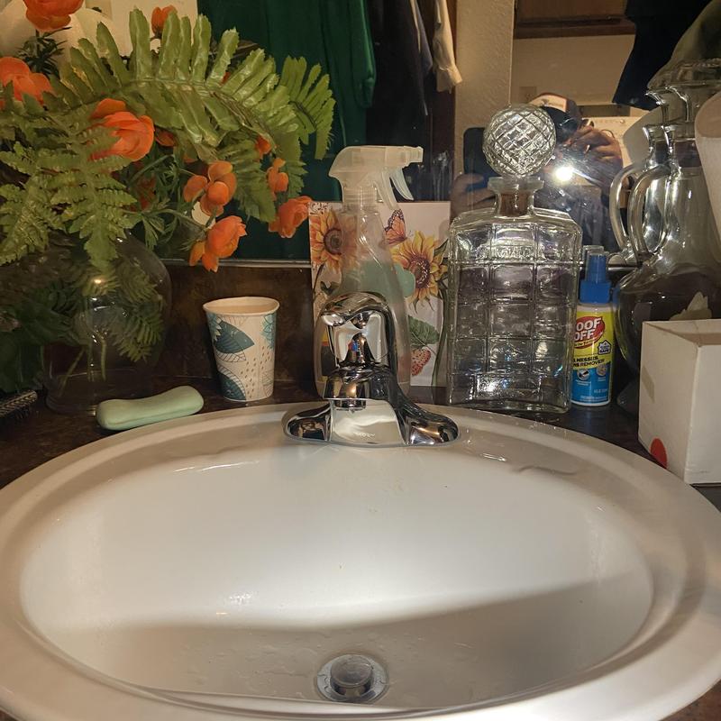 Bathroom sink and faucet with countertop items
