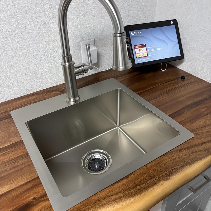 Stainless steel kitchen sink with pull-down faucet installed Stainless steel kitchen sink with pull-down faucet installed