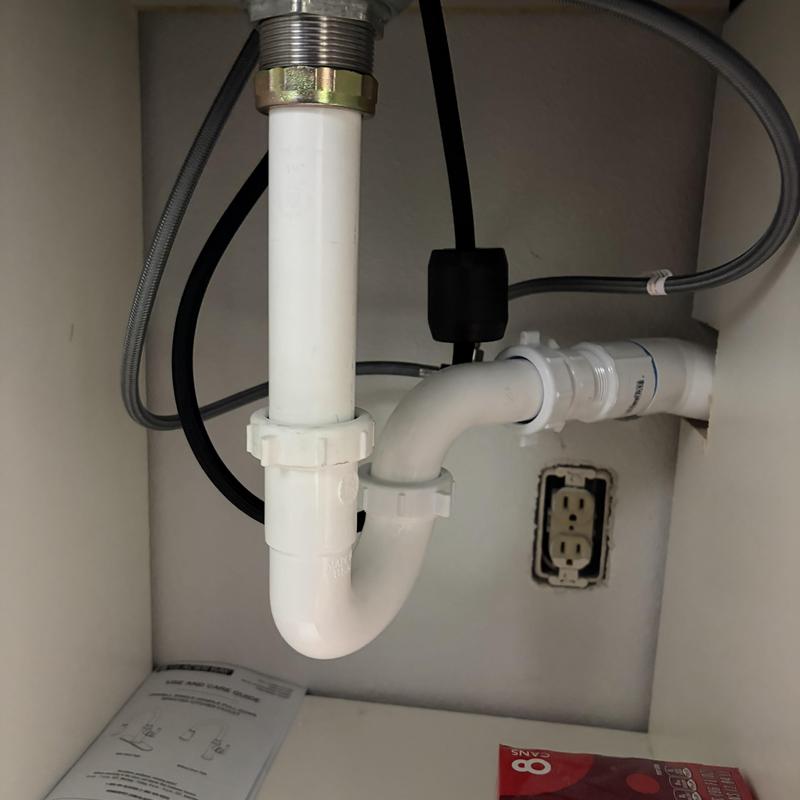 Kitchen sink PVC drain trap and pipe connection under cabinet Kitchen sink PVC drain trap and pipe connection under cabinet