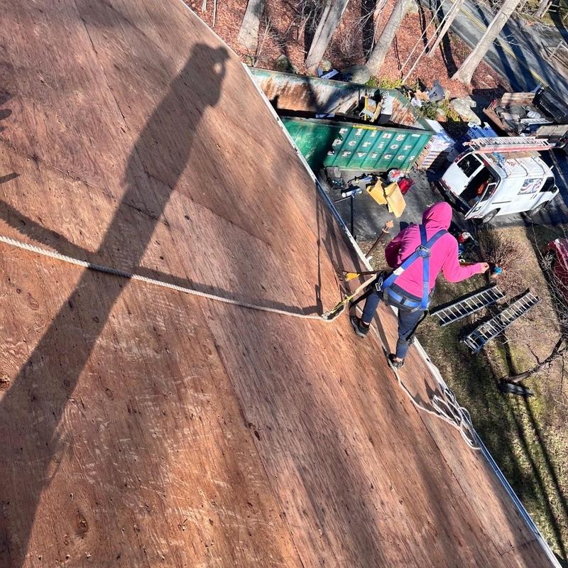 Roof plywood decking installation with safety harness