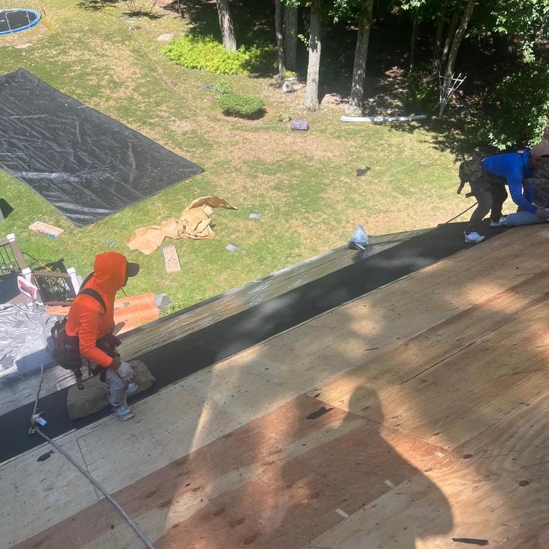 Plywood roof decking installation with safety harnesses