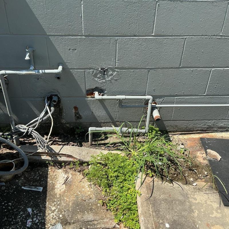 Backflow preventer installation and piping on concrete wall Backflow preventer installation and piping on concrete wall