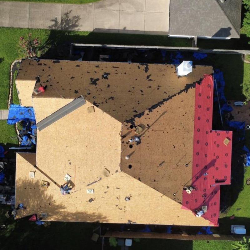 Residential roof decking installation with red underlayment
