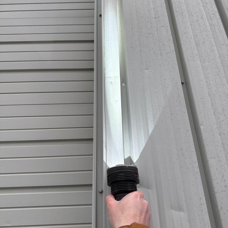 Metal roofing panel with hail damage inspection