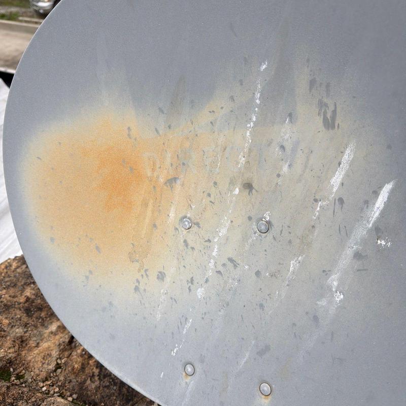 Satellite dish with rust and surface damage