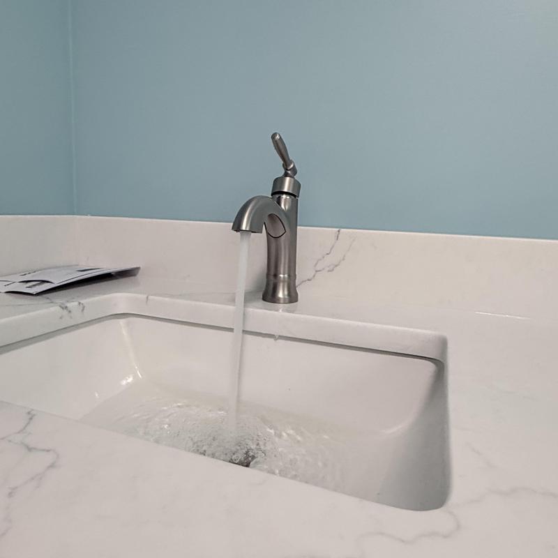 Customer supplied faucet with water running in sink Customer supplied faucet with water running in sink