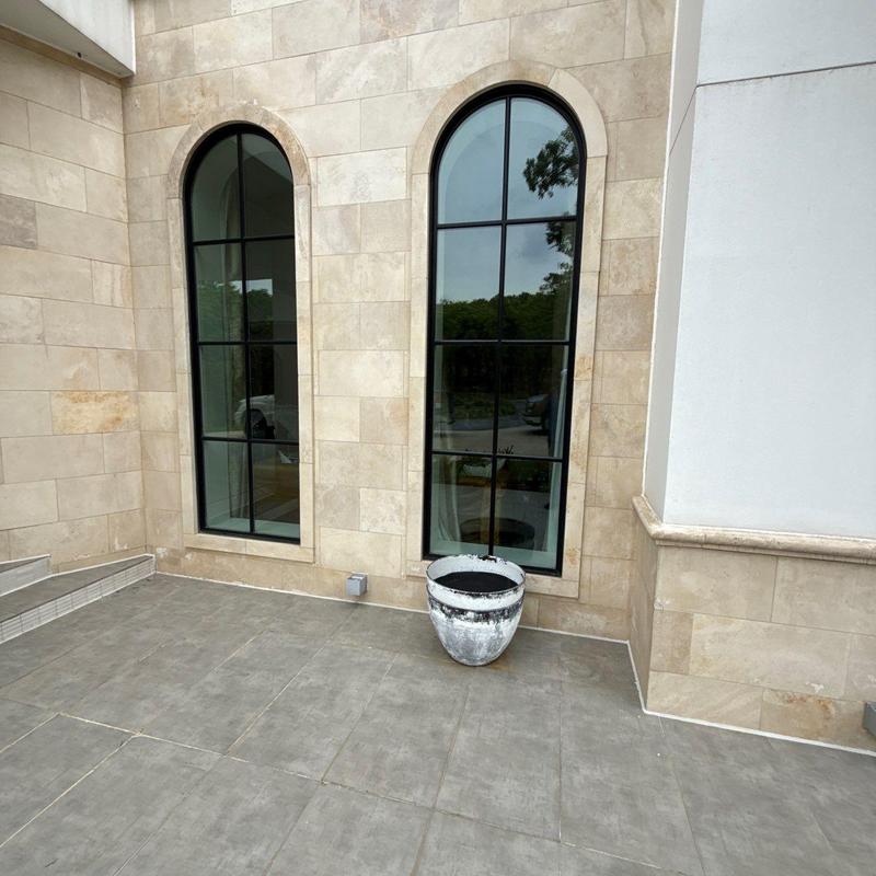 Stucco and stone exterior wall with windows inspection