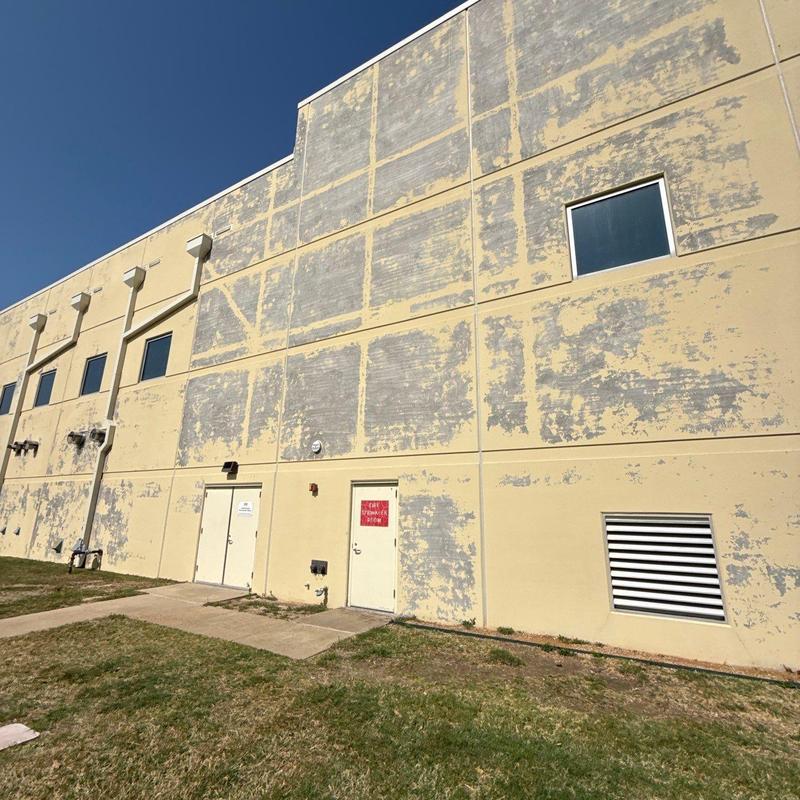 Tilt wall exterior with peeling paint on commercial building