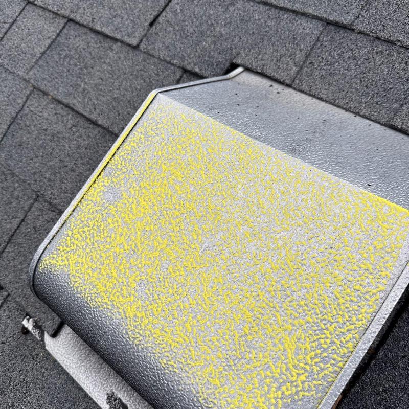 Roof vent with hail damage on asphalt shingles