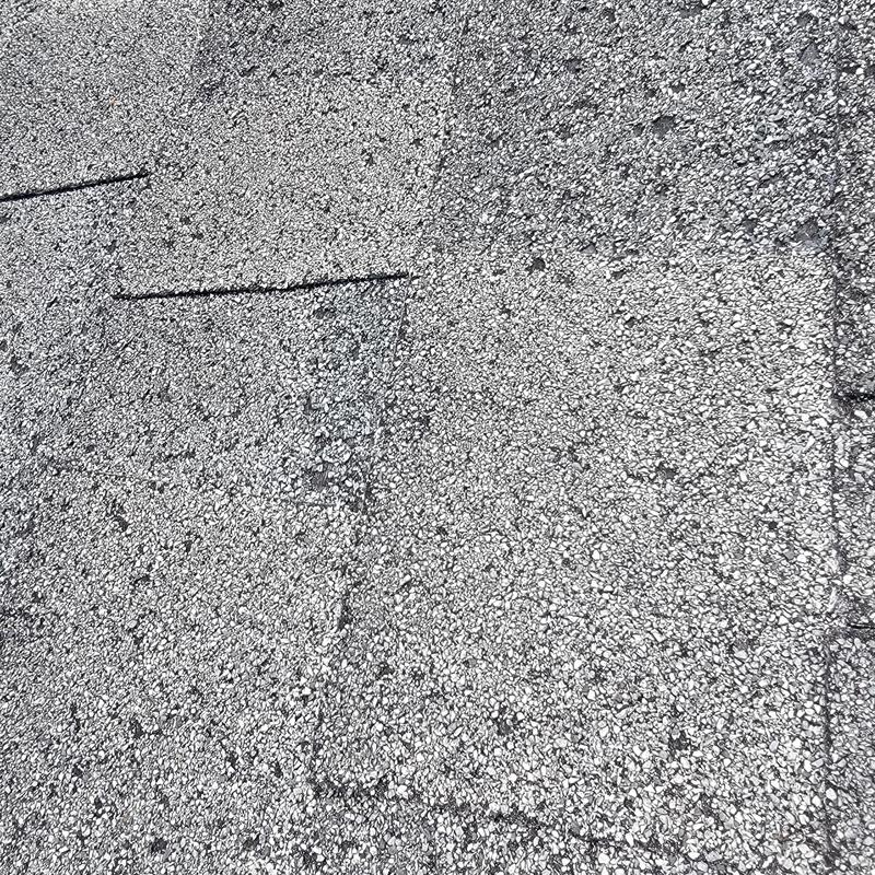 Asphalt roof shingles with hail damage and markings Asphalt roof shingles with hail damage and markings