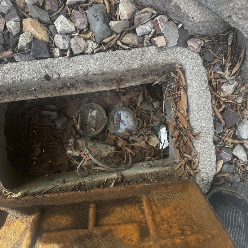 Water meter inside outdoor valve box with debris Water meter inside outdoor valve box with debris