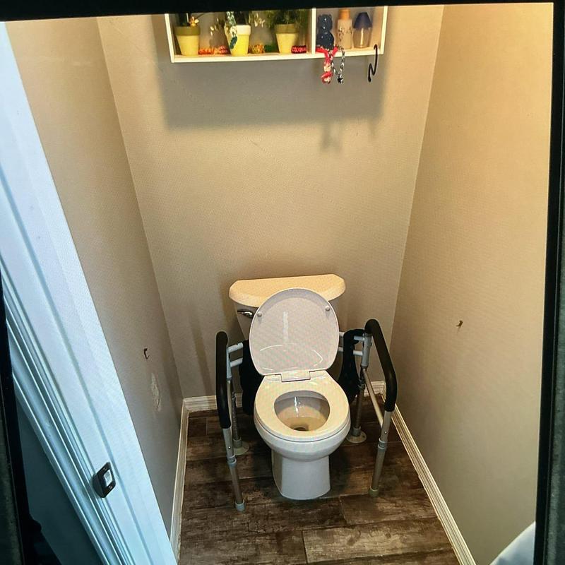 American Standard toilet with safety rails installed