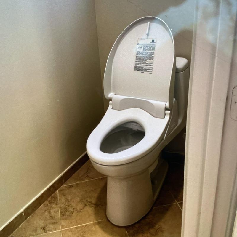 Toto toilet with open lid installed on tiled floor