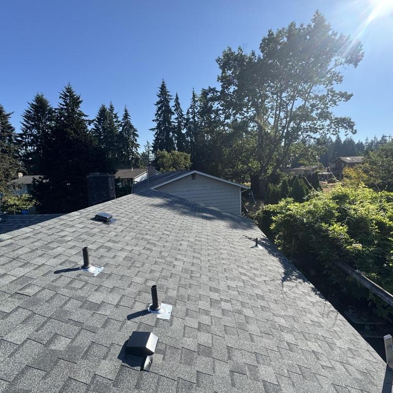 Asphalt shingle roof with vents installed on sunny day