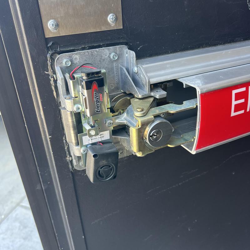 Panic bar lock mechanism with Energizer battery installed Panic bar lock mechanism with Energizer battery installed