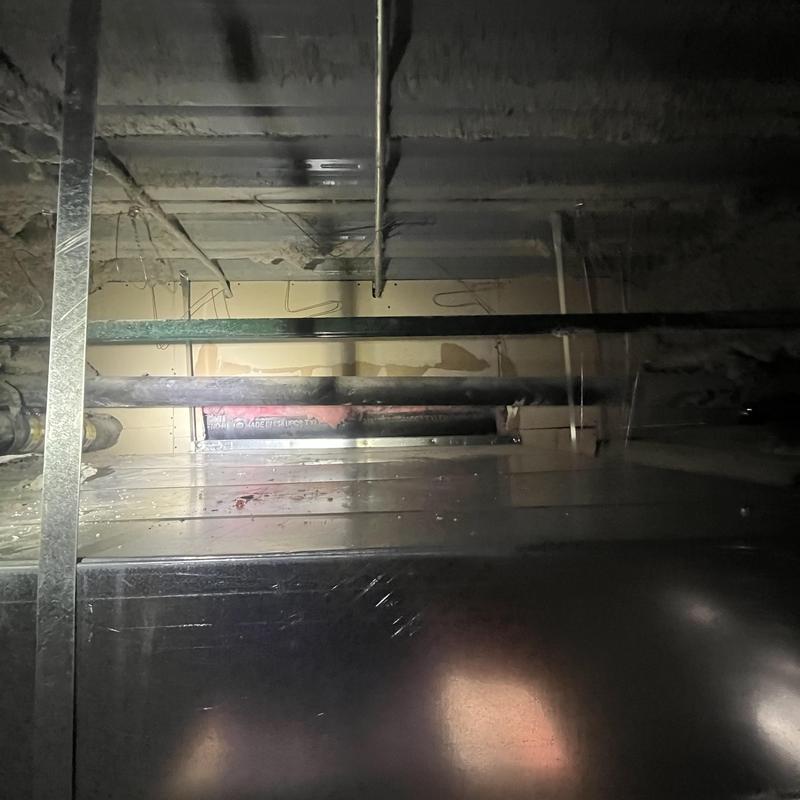 Cast iron waste drainage pipes in basement ceiling installation Cast iron waste drainage pipes in basement ceiling installation