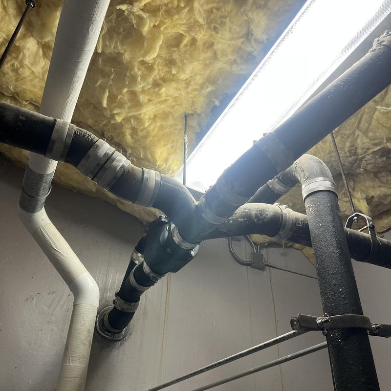 Cast iron waste lines piping in basement ceiling Cast iron waste lines piping in basement ceiling