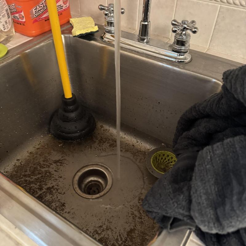 Laundry sink drain with plunger clearing blockage Laundry sink drain with plunger clearing blockage
