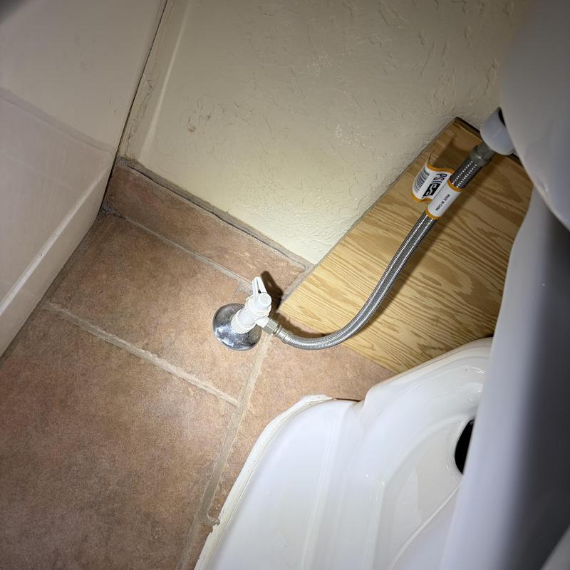 Toilet supply line with shutoff valve on tile floor Toilet supply line with shutoff valve on tile floor