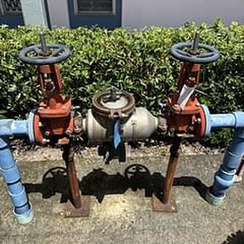 Backflow prevention device with valves and piping outdoors