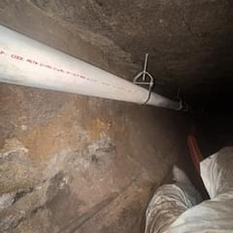 PVC drain pipe installation in crawl space