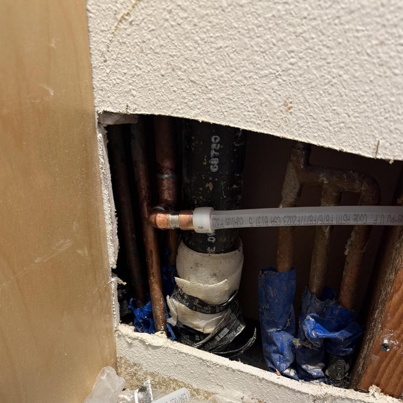 Half-inch PEX water line reroute behind drywall cutout
