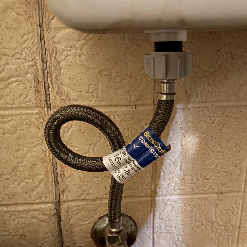Toilet supply line with brass connector installed
