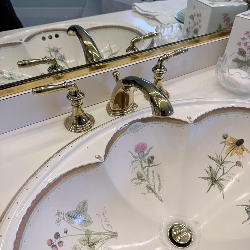 Gold faucet and floral sink on double vanity Gold faucet and floral sink on double vanity