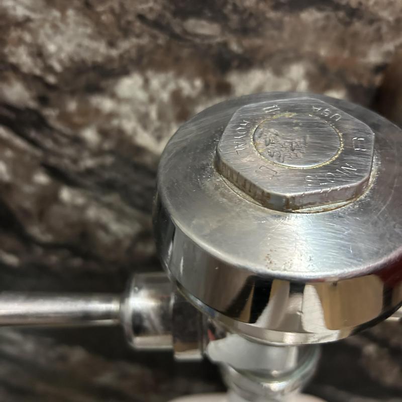 Commercial flush valve close-up on water hammer repair job Commercial flush valve close-up on water hammer repair job