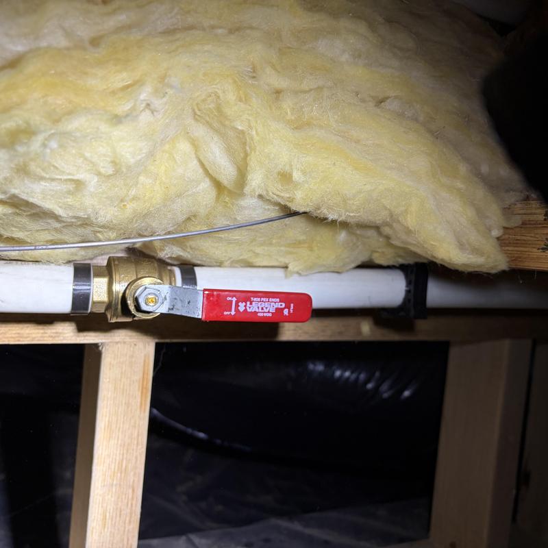 Ball valve with red handle in insulated ceiling cavity Ball valve with red handle in insulated ceiling cavity