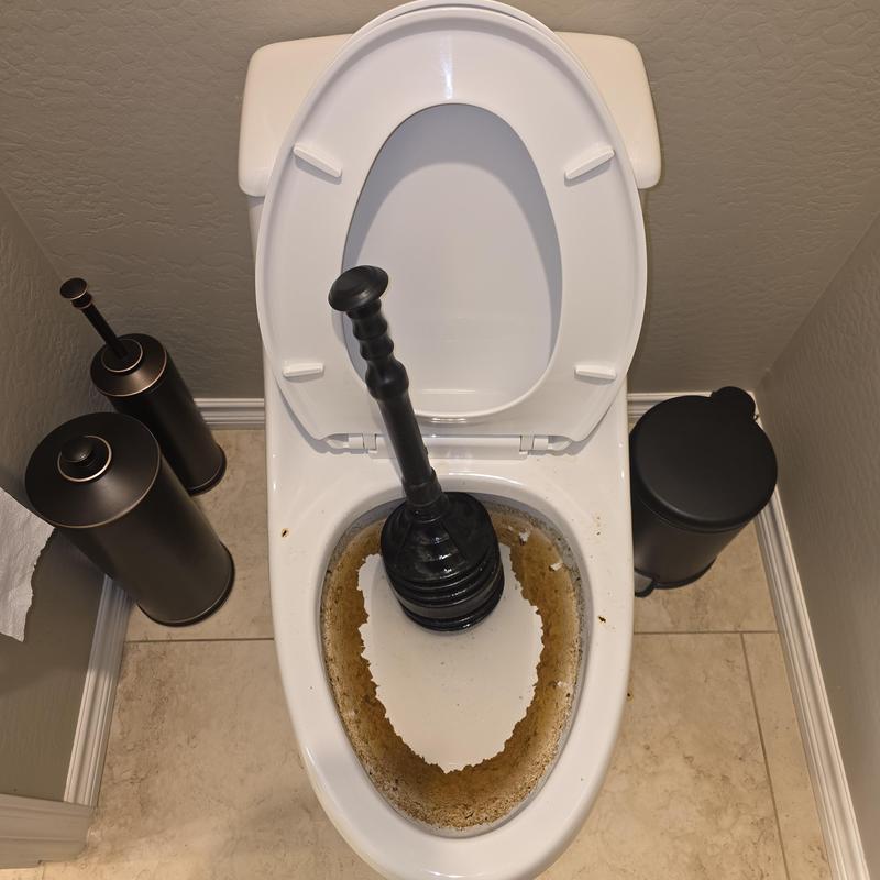 Toilet bowl with plunger clearing blockage