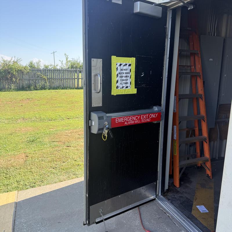 Exit device and lock on emergency delivery door Exit device and lock on emergency delivery door