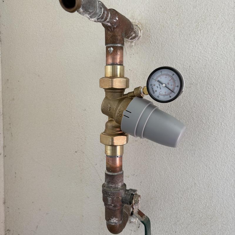 1-inch pressure regulator with gauge on copper pipe