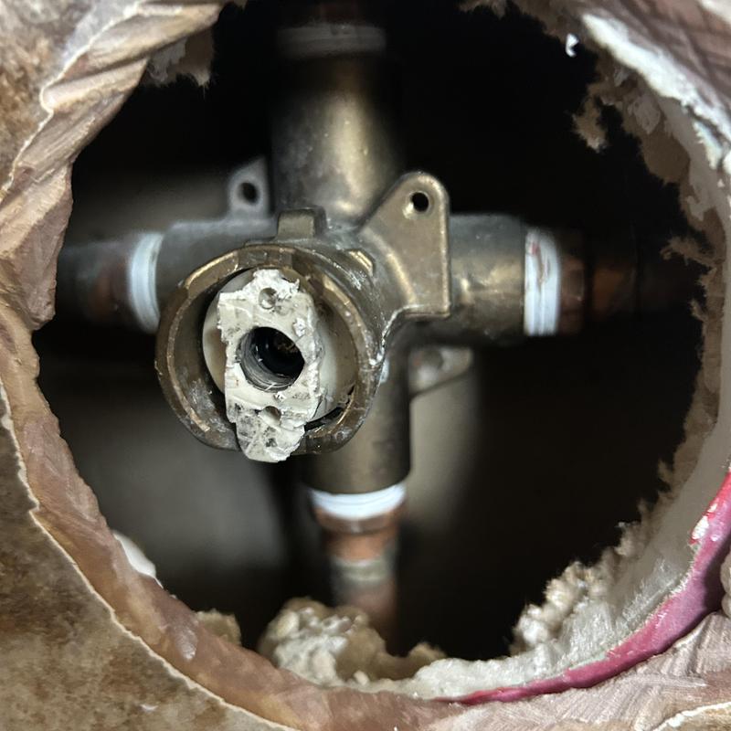 Shower valve with broken handle removed in wall cavity Shower valve with broken handle removed in wall cavity