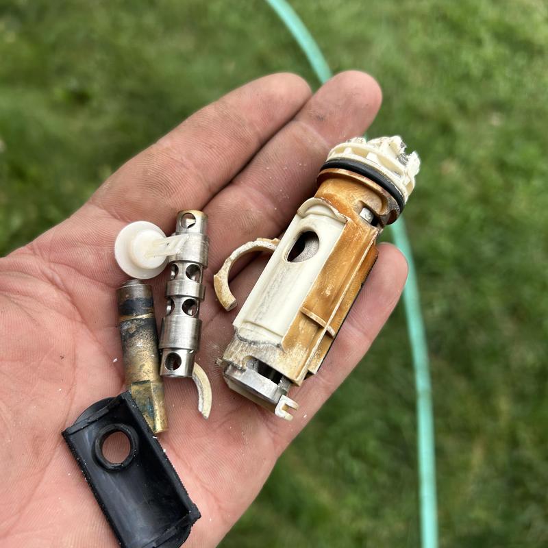 Shower valve internals removed for repair in hand Shower valve internals removed for repair in hand