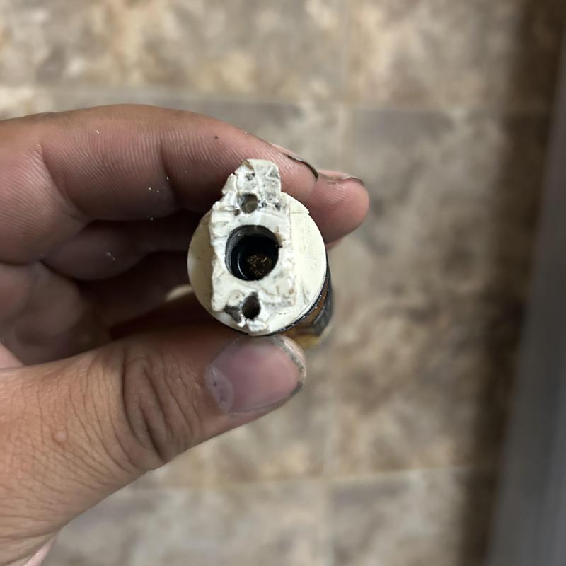 Shower handle valve cartridge removed showing damage Shower handle valve cartridge removed showing damage