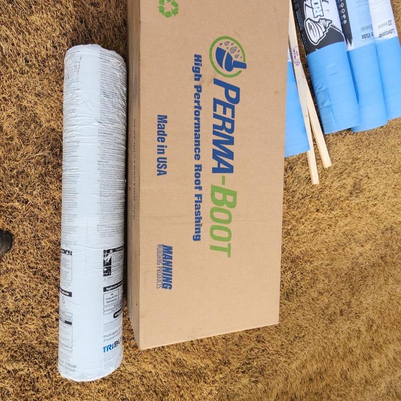 Roof flashing materials and underlayment rolls on grass Roof flashing materials and underlayment rolls on grass