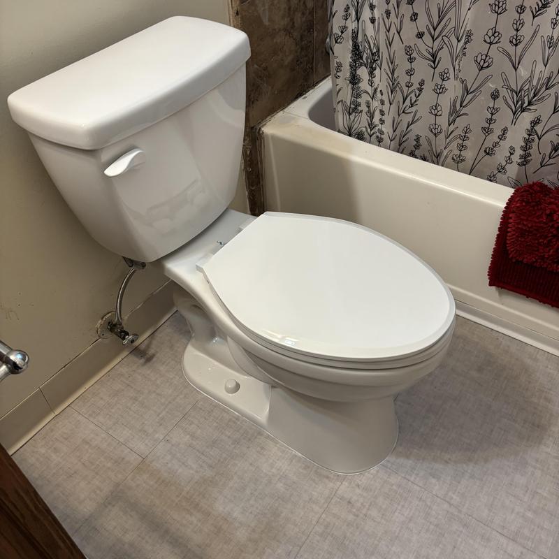 Toilet installation with new wax ring and caulking