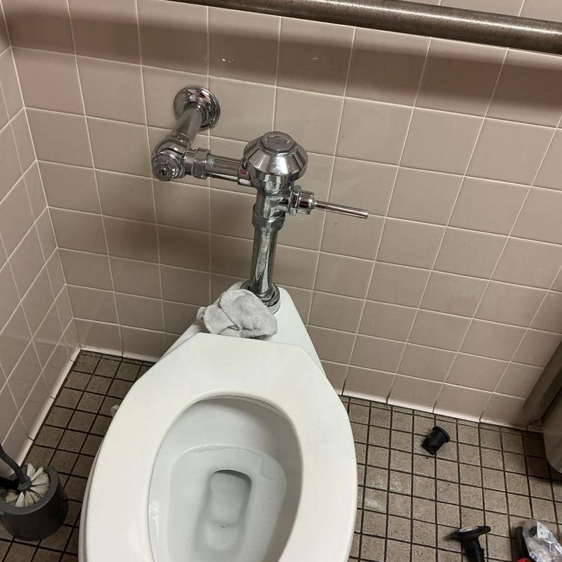 Toilet flush valve with handle replacement in restroom Toilet flush valve with handle replacement in restroom