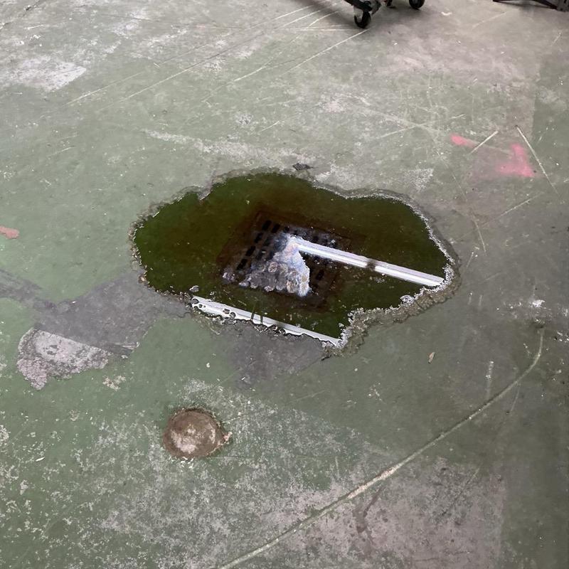 Cast iron floor drain with standing water and rust damage Cast iron floor drain with standing water and rust damage