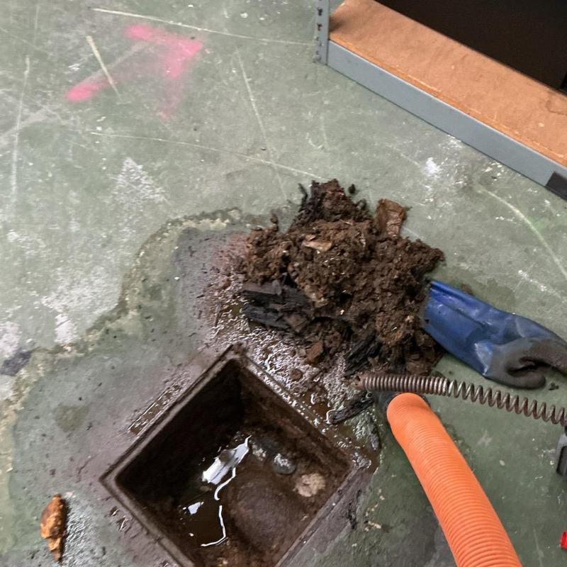 Cast iron drain with clog and removed debris Cast iron drain with clog and removed debris
